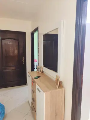 a room with a dresser with a mirror and a door at Appartement propre et bien équipé à Ain sebaa in Casablanca