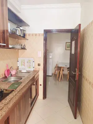 a kitchen with a sink and a counter top at Appartement propre et bien équipé à Ain sebaa in Casablanca