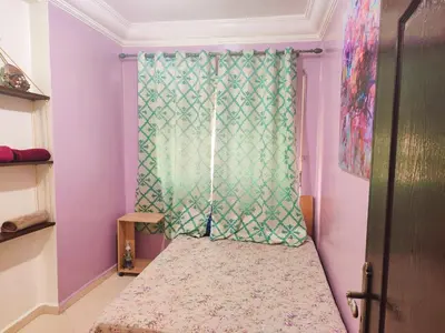 a small room with a window with a curtain at Appartement propre et bien équipé à Ain sebaa in Casablanca