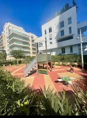 a bench sitting in front of a building at Casablanca Appartement haut standing CFC in Casablanca