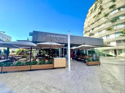 a market with umbrellas and tables and a building at Casablanca Appartement haut standing CFC in Casablanca
