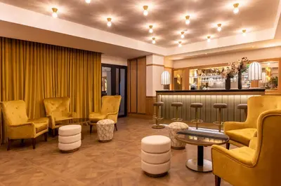 a waiting room with yellow chairs and a bar at Best Western Plus Casablanca City Center in Casablanca