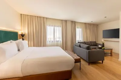 a hotel room with a large bed and a couch at Best Western Plus Casablanca City Center in Casablanca