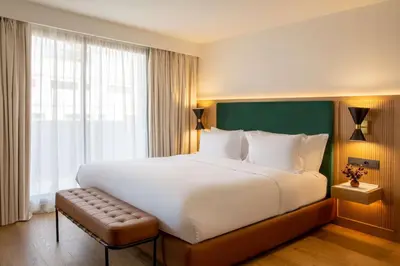 a bedroom with a large bed and a large window at Best Western Plus Casablanca City Center in Casablanca