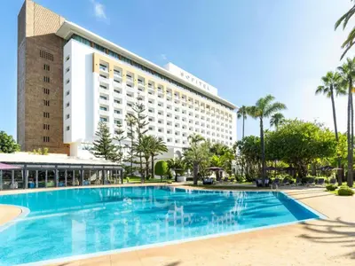 a swimming pool in front of a hotel at Sofitel Rabat Jardin Des Roses in Rabat