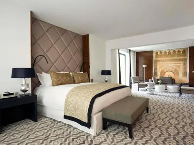 a bedroom with a large bed and a living room at Sofitel Rabat Jardin Des Roses in Rabat