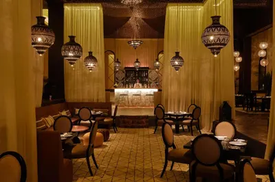 a restaurant with tables and chairs and a fireplace at Mazagan Beach & Golf Resort in El Jadida