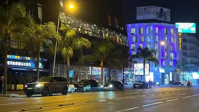 a city street at night with cars parked on the street at ZEN Suites Hotel Massira in Casablanca
