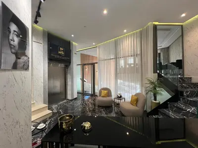 a lobby with two chairs and a table in a building at ZEN Suites Hotel Massira in Casablanca
