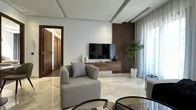 a living room with a couch and a tv at Charming and Central 2 Bedrooms - By AppartAli in Casablanca