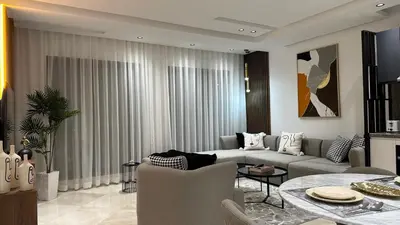 a living room with a couch and a table at Charming and Central 2 Bedrooms - By AppartAli in Casablanca