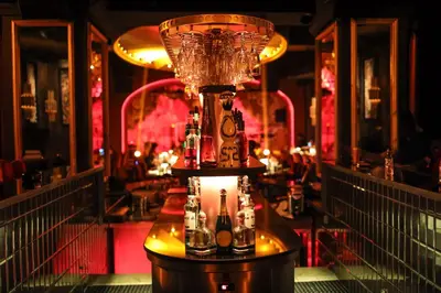 a drink dispenser with bottles on a table in a bar at Villa Blanca Urban Hotel in Casablanca
