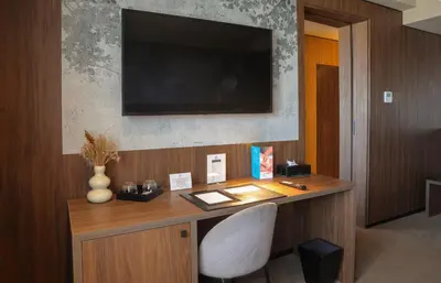 a room with a desk with a television on a wall at Villa Blanca Urban Hotel in Casablanca