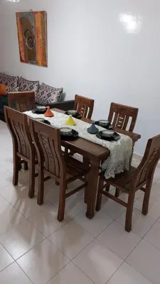 a dining room table and chairs with a table and a couch at harmony house 2 in Rabat
