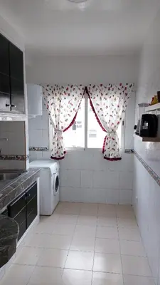 a kitchen with a washing machine and a window at harmony house 2 in Rabat