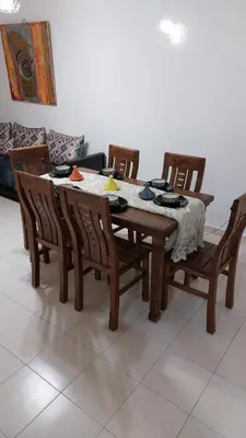a dining room table with chairs and a tablecloth on it at harmony house 2 in Rabat