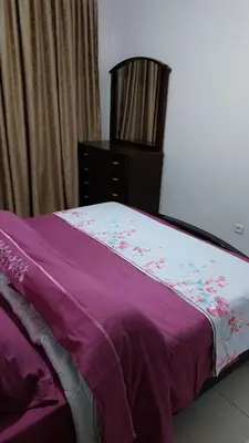 a purple bed with a dresser in a bedroom at harmony house 2 in Rabat