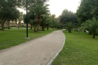 a walking path in a park with palm trees at Architects Haven in Luxury 3BR - Near Train & Tramway in Casablanca