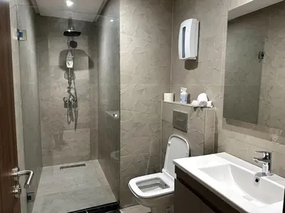 a bathroom with a shower and a toilet and a sink at Casa by Casablanca in Casablanca