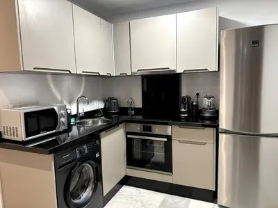 a kitchen with a refrigerator microwave and a washer at Casa by Casablanca in Casablanca