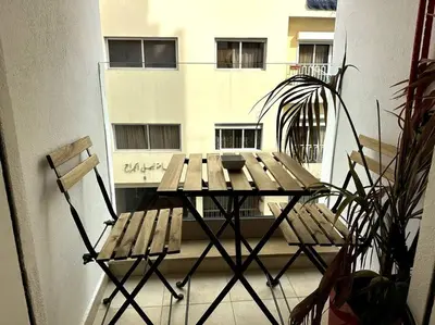 a table and chairs on a balcony with a building at Casa by Casablanca in Casablanca