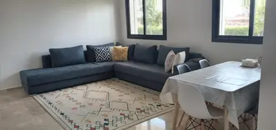 a living room with a blue couch and a table at Garden Bay - Appartement en bord de mer in Tamaris