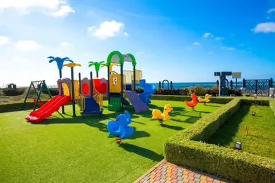 a park with a playground with a slide at Garden Bay - Appartement en bord de mer in Tamaris