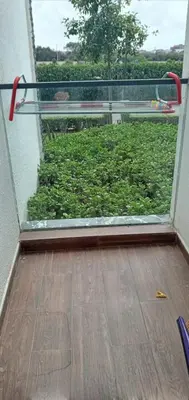 a glass door with a view of a green bush at Garden Bay - Appartement en bord de mer in Tamaris