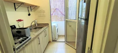 a small kitchen with a sink and a refrigerator at joli appartement près de la mer in Casablanca