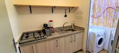 a kitchen with a sink and a washing machine at joli appartement près de la mer in Casablanca