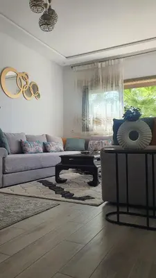 a living room with a couch and a table at HEAVEN BEACH in Sidi Rahal