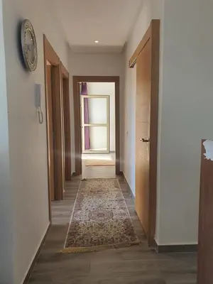 a hallway with an open door and a clock on a wall at HEAVEN BEACH in Sidi Rahal