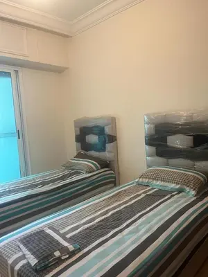 a room with two beds in a room at Appartement avec piscine proche de la plage in Mohammedia