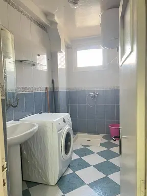 a bathroom with a washing machine and a sink at Housse F2 famille in Rabat