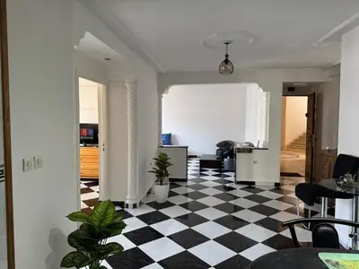 a room with a black and white checkered floor at Housse F2 famille in Rabat