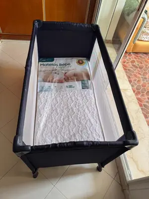 an open suitcase with a magazine in it at Housse F2 famille in Rabat