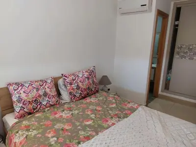 a bed with pillows on it in a bedroom at BLANCA BEACH Sidi Rahal Front Mer in Sidi Rahal