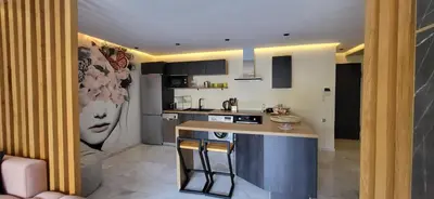 a kitchen with a counter and a kitchen island in a room at L'Amouage Casablanca Location Journalière Casablanca in Casablanca
